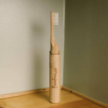 Load image into Gallery viewer, An eco-friendly, travel toothbrush made of bamboo with nylon bristles by bamboo switch stands upright.
