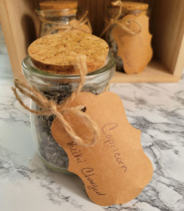 Close up of a jar of Capricorn-inspired, reiki-charged bath salts in 4 oz glass jar with cork and paper tag.