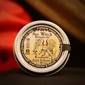 Solid perfume in "Krampus," a winter spice blend, in a tin. Made by Sea Witch Botanicals