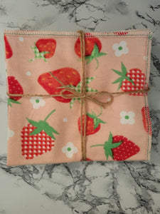 Close up of reusable unpaper towel in strawberry pattern. Wrapped in twine. Made in Montgomery County, MD