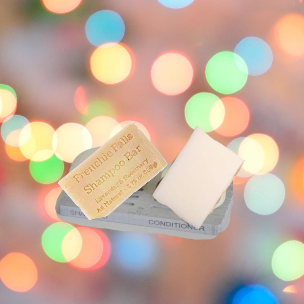 A diatomite soap dish with shampoo and conditioner bars. 