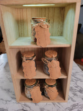 Load image into Gallery viewer, Zodiac-inspired, reiki-charged bath salts in small glass jars displayed on a wooden shelf.
