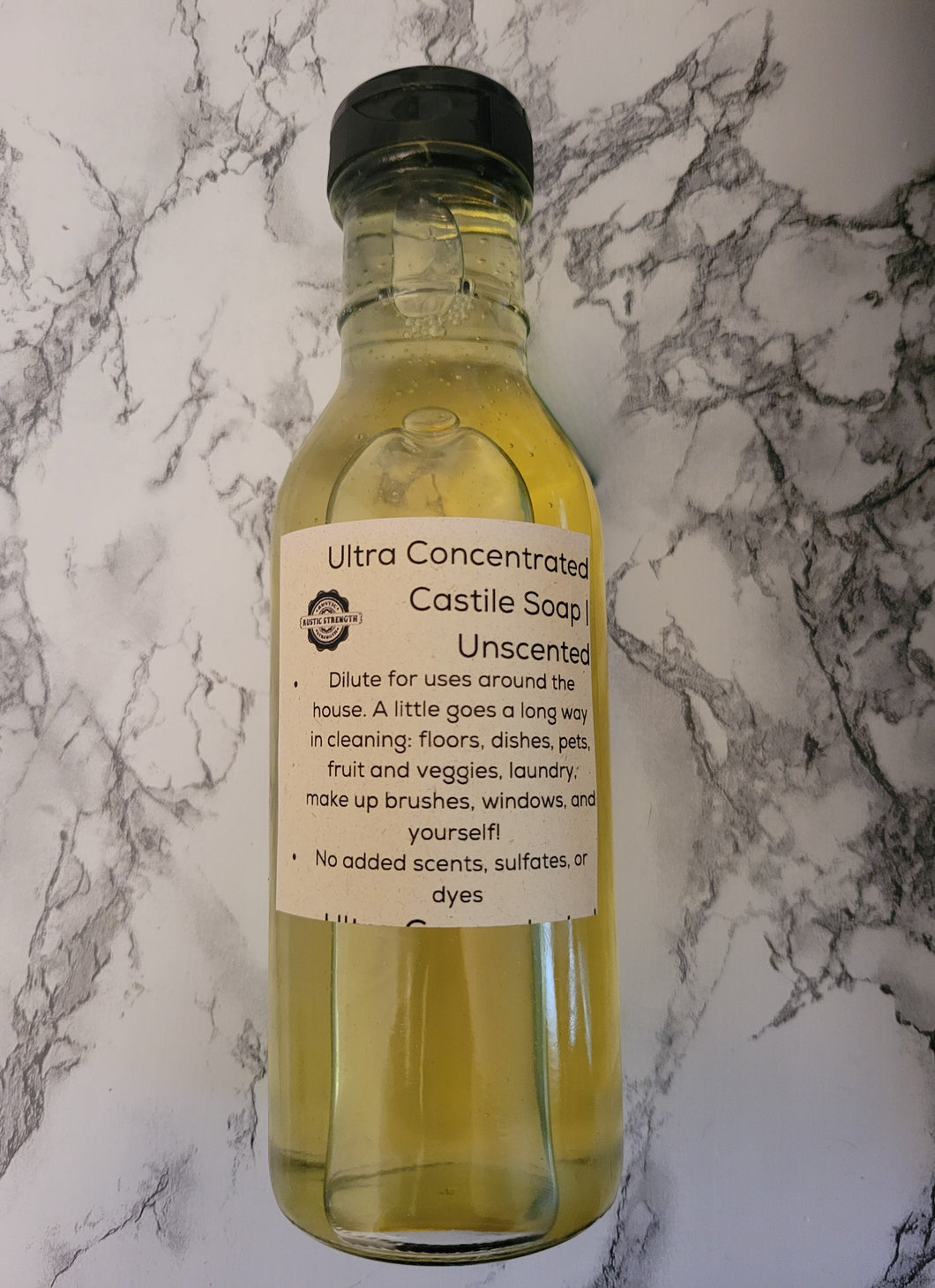 An upcycled glass jar, pre-filled with Rustic Strength brand ultra-concentrated Castile soap.