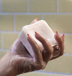 Photo from Dip showing a lathered shampoo bar in the shower.